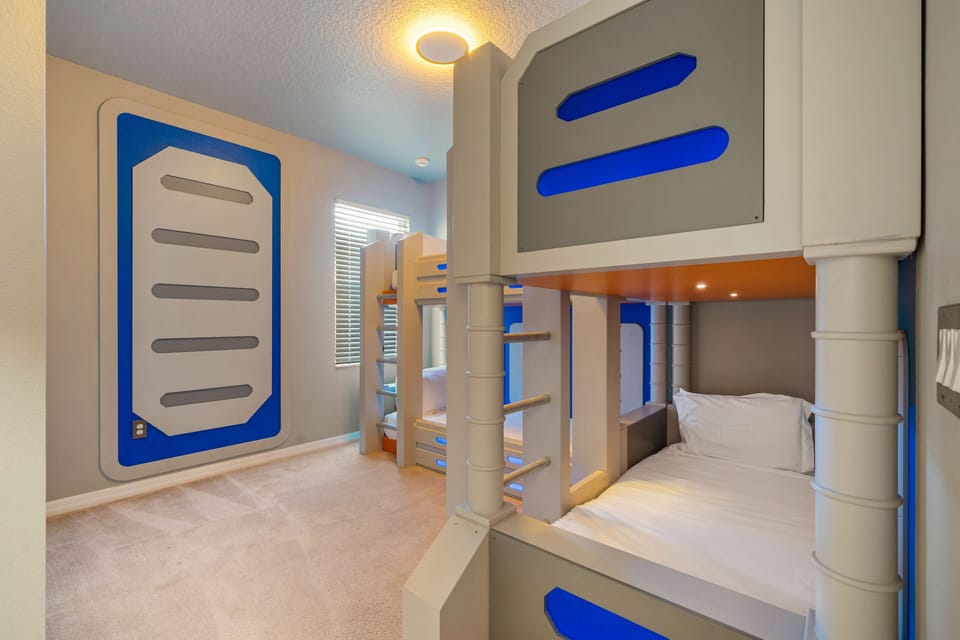 - Space themed bunk bedroom with creative wall designs  
- Perfect kids room in Orlando vacation rental near Disney  
- Bright playful sleeping space for families and children