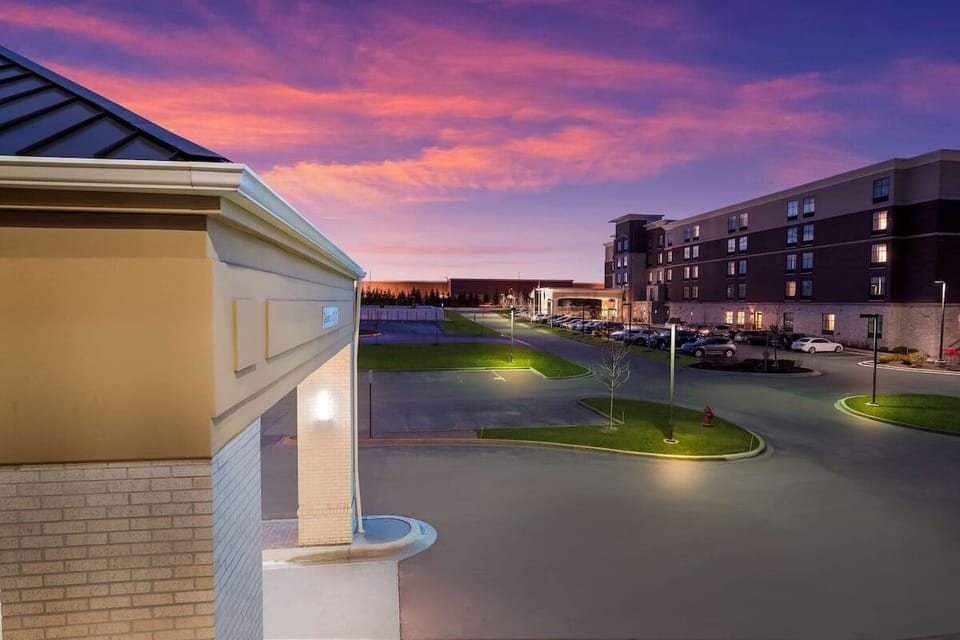 Arrive at sunset to a welcoming, beautifully lit hotel exterior.