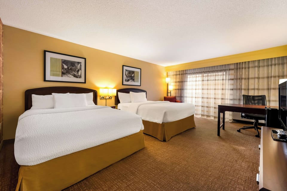 Unwind in bright comfort with two plush beds and space.