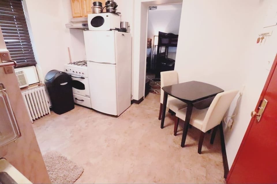 Stove and Fridge with entryway into the bedroom.  We have AC in both rooms. 