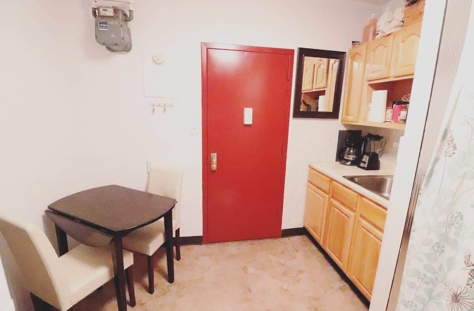 Dining Table with the door to the hallway of the building. 
Building is a 6 story brownstone in LIttle Italy, NYC