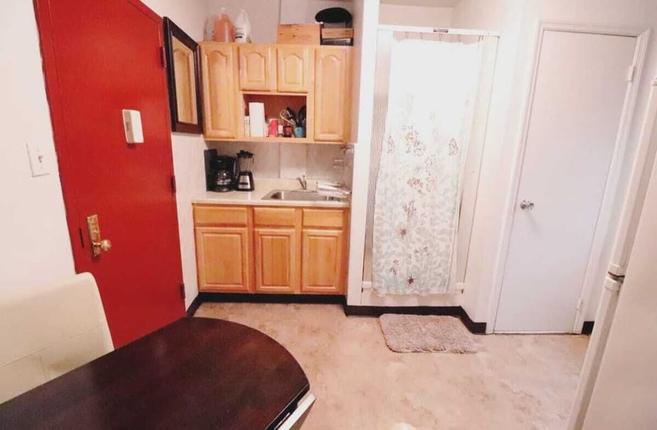 Kitchen, Shower and Bathroom Door.    The door between this room and the bedroom can seperate and give privacy.  Kitchen is fully stocked with all cooking needs, coffee maker, microwave, stove, etc