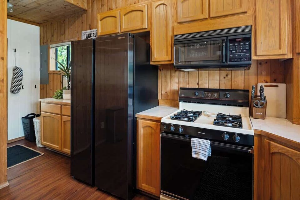 Second kitchen off of the main kitchen with an additional stove top, oven, fridge, and 
