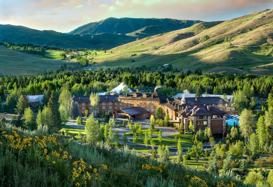 Escape to a mountain resort nestled in golden evening light