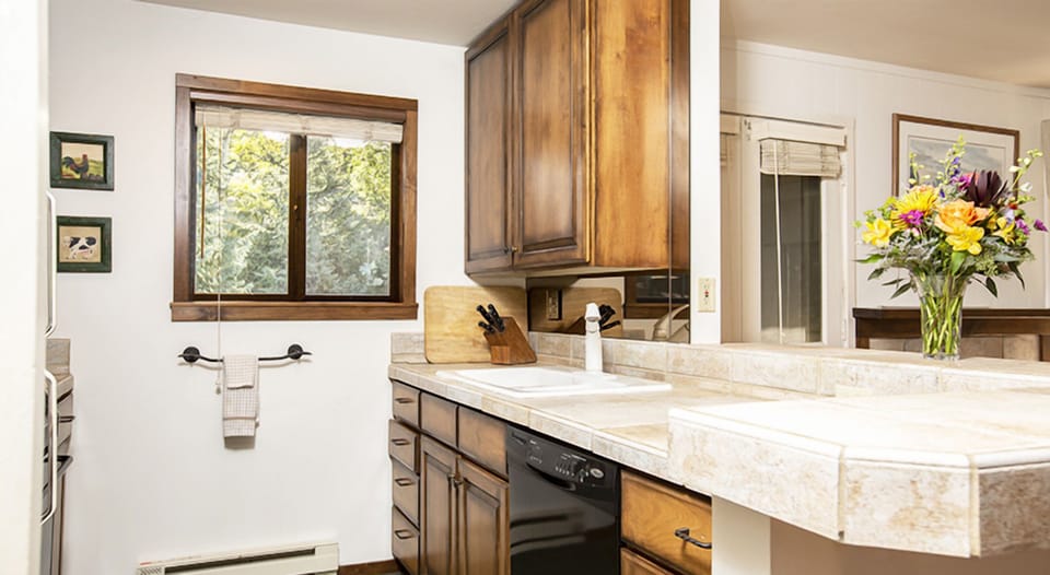 Prep simple bites on generous counters with a leafy view.