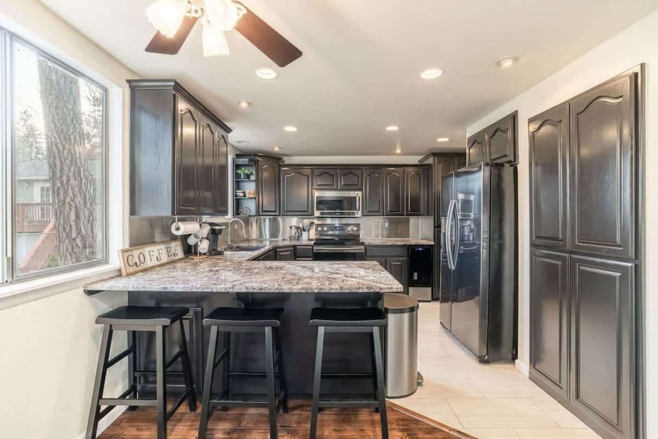 Open kitchen with bar stool seating and fully stocked for cooking 
