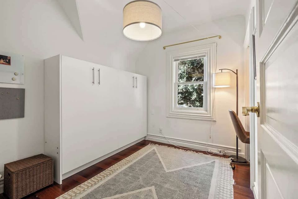 Built-in cabinet and storage area with clean white finishes.