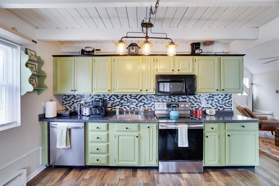 Fully equipped kitchen with modern appliances, charming cabinetry, and all the essentials for home-cooked meals.