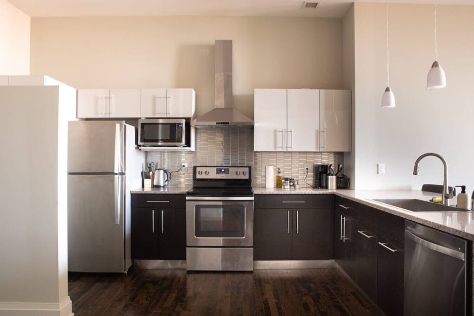 A fully-equipped kitchen featuring high-end finishes and bar seating—everything you need to prep, cook, and refuel