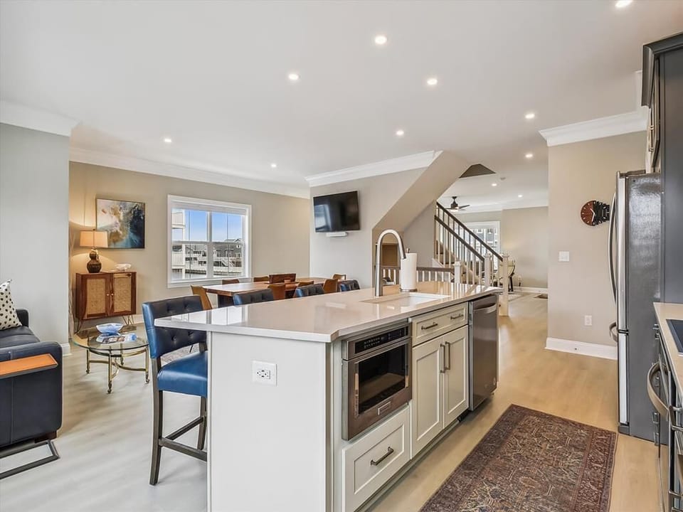 Another view of the stunning kitchen, showcasing the open floor plan and bright, airy design.