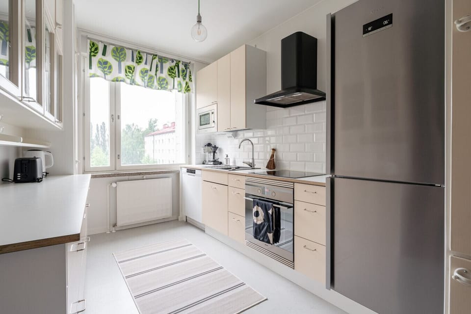 Prepare your favorite meals in this fully equipped kitchen, featuring modern appliances and plenty of counter space for your convenience.