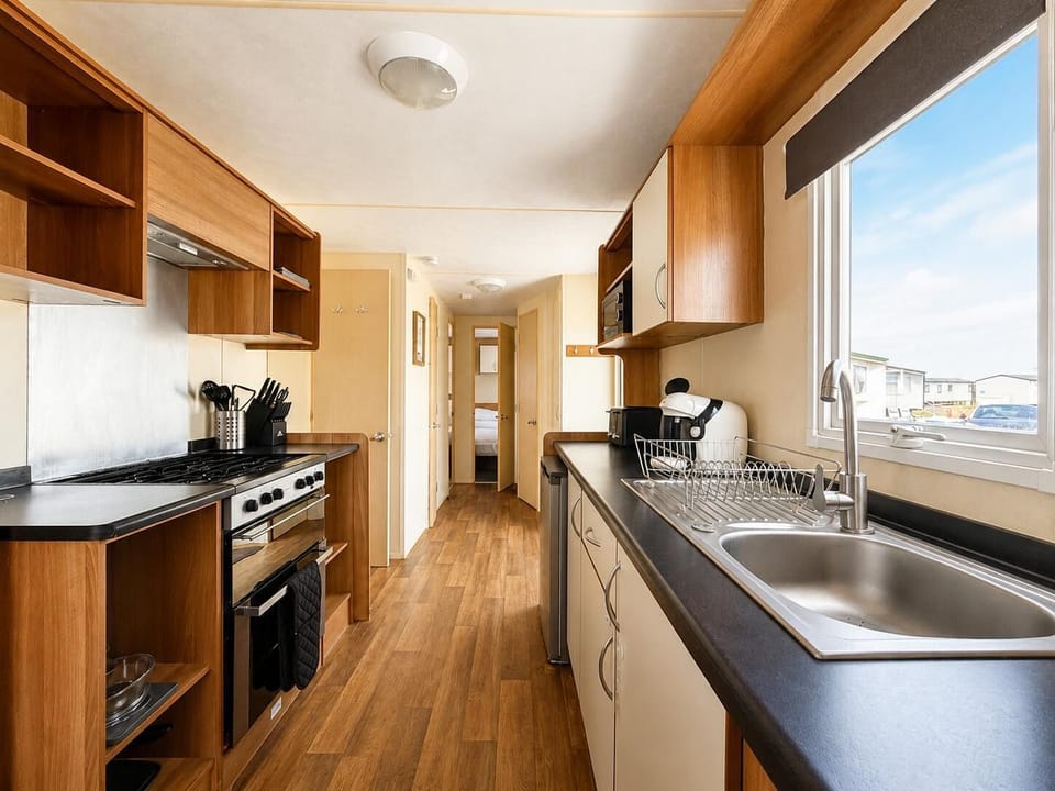 The kitchen in the static caravan is perfect for creating quick meals before heading out to explore.