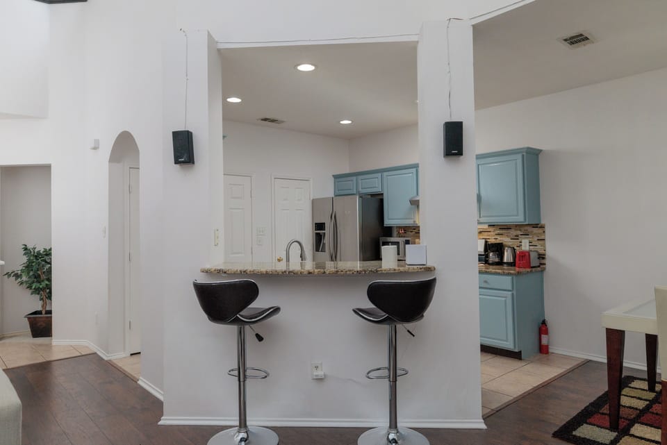 Kitchen pass through with seating for 2 at the bar height counter.