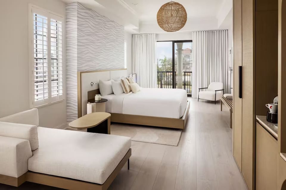 Wake refreshed in a sunlit suite with balcony breezes.