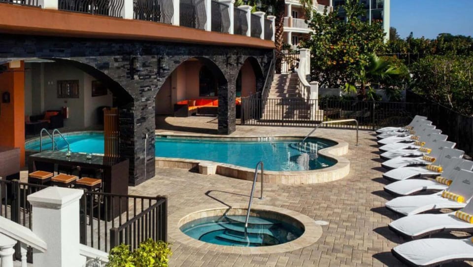 Slip into the hot tub, then lounge beside the pool.