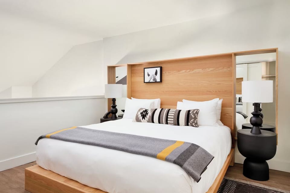 Unwind in a serene king bed with designer comfort.
