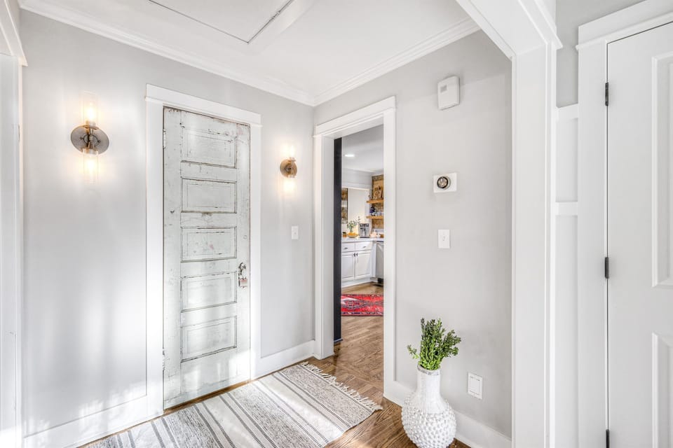 Central hallway with beautiful, reclaimed door to second full bathroom