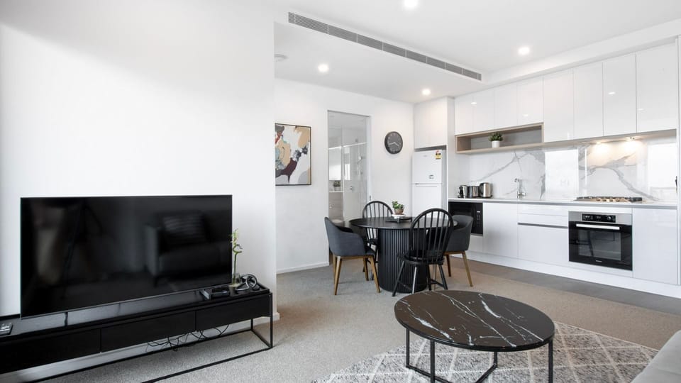 Spacious living area with a large TV and inviting lounge setup.