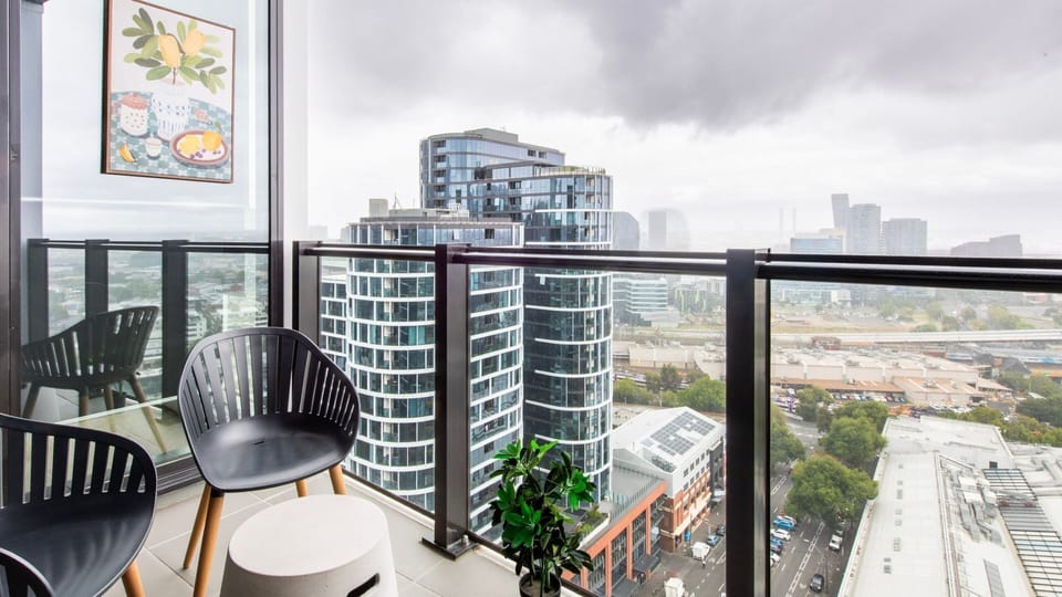 Private balcony seating overlooking Melbourne’s skyline.