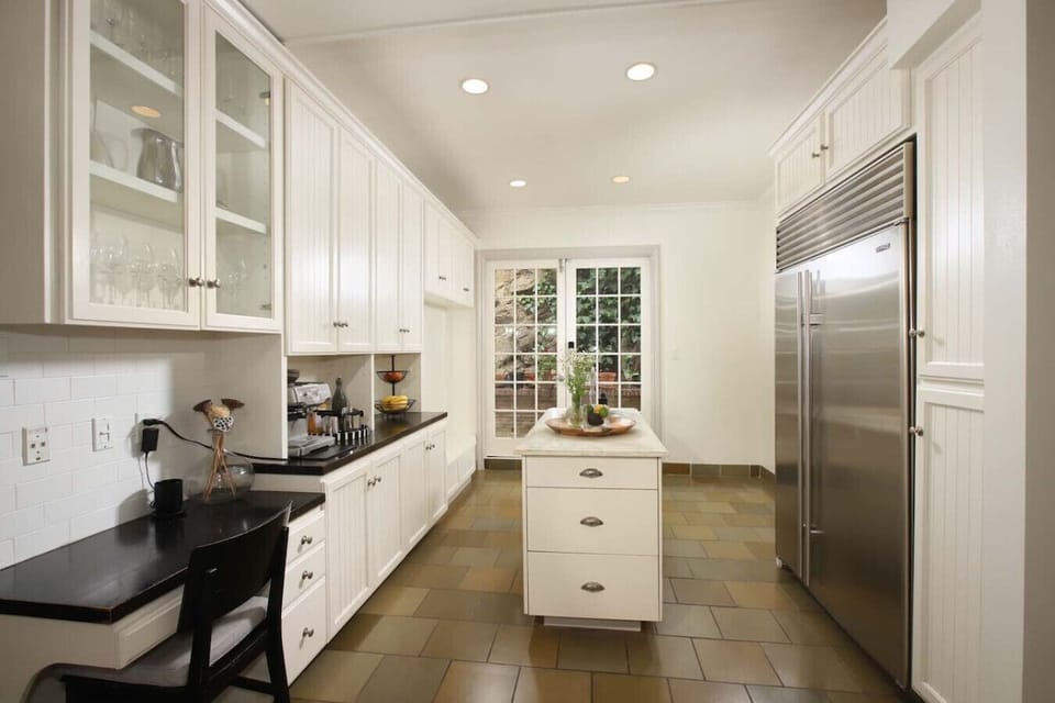 Spacious kitchen with a sleek center island for dining and meal prep.