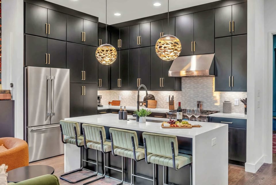 The open kitchen and island become command central for the group. Four bar stools mean the cook is never left out of the conversation while prep happens