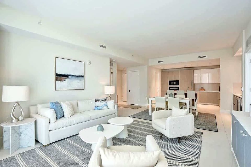 Living area with open kitchen and dining visible