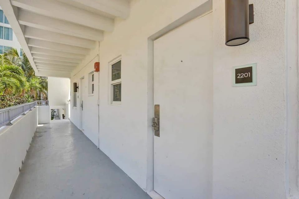 Covered exterior walkway leading to the unit entrance.