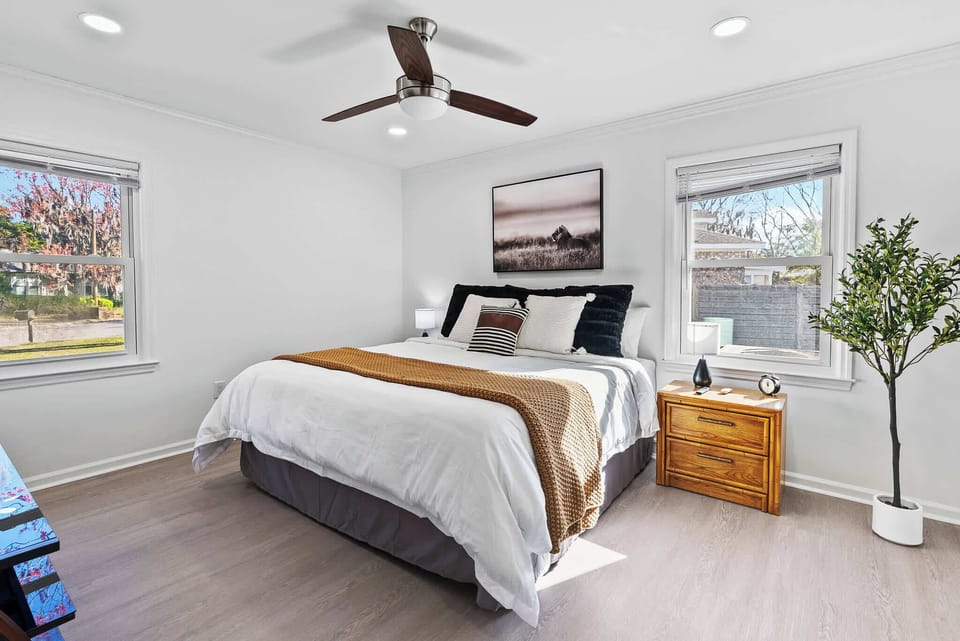 Serene master bedroom with a king bed, natural light, and calming views.