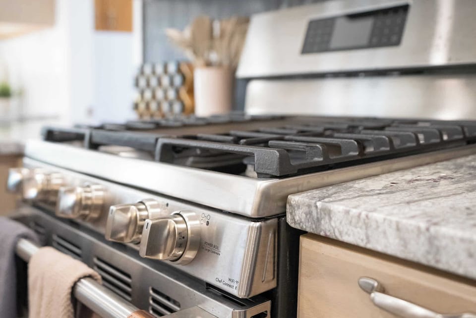 Modern kitchen with a stainless steel gas range, perfect for cooking up delicious meals.