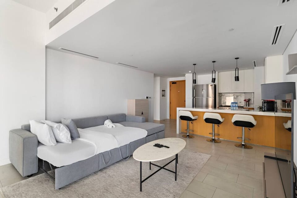 Living Room: Bright, airy space with sleek furniture and a stylish kitchen bar for entertaining!