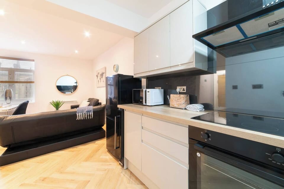 A spacious open-plan kitchen equipped with modern appliances and a washing machine—perfect for longer stays.