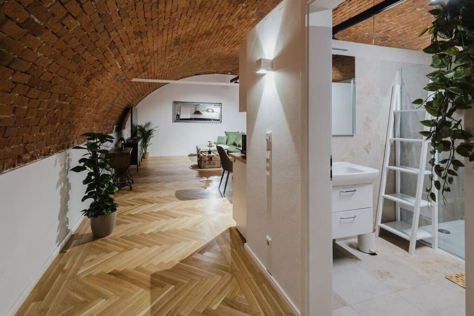 Welcoming living area with warm wood floors and unique historic design.
