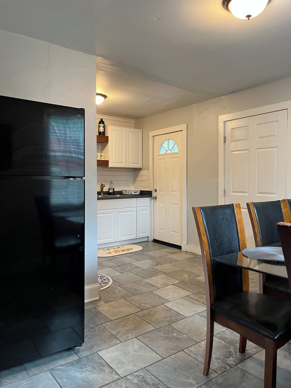Open-concept kitchen and dining area with seating for five.