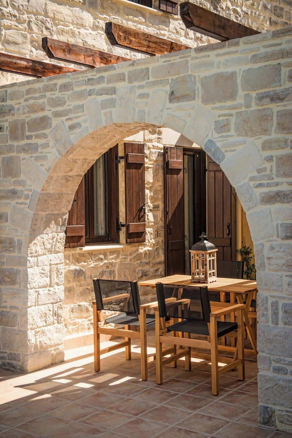 Outdoor Dining Area of Villa Dafne – Enjoy alfresco meals in a shaded stone courtyard surrounded by local charm.