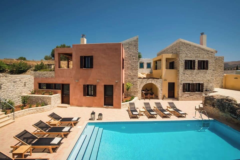 Villa Dafne and Kastalia – View of Both Villas – A stunning ensemble of stone-built residences with shared pool and sea views.