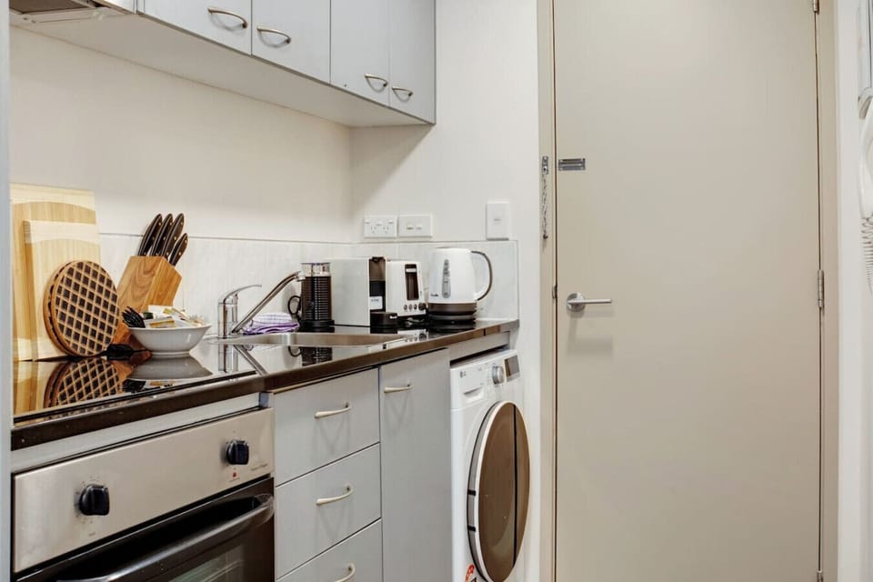 The combo washing machine and dryer is located in the kitchen area.