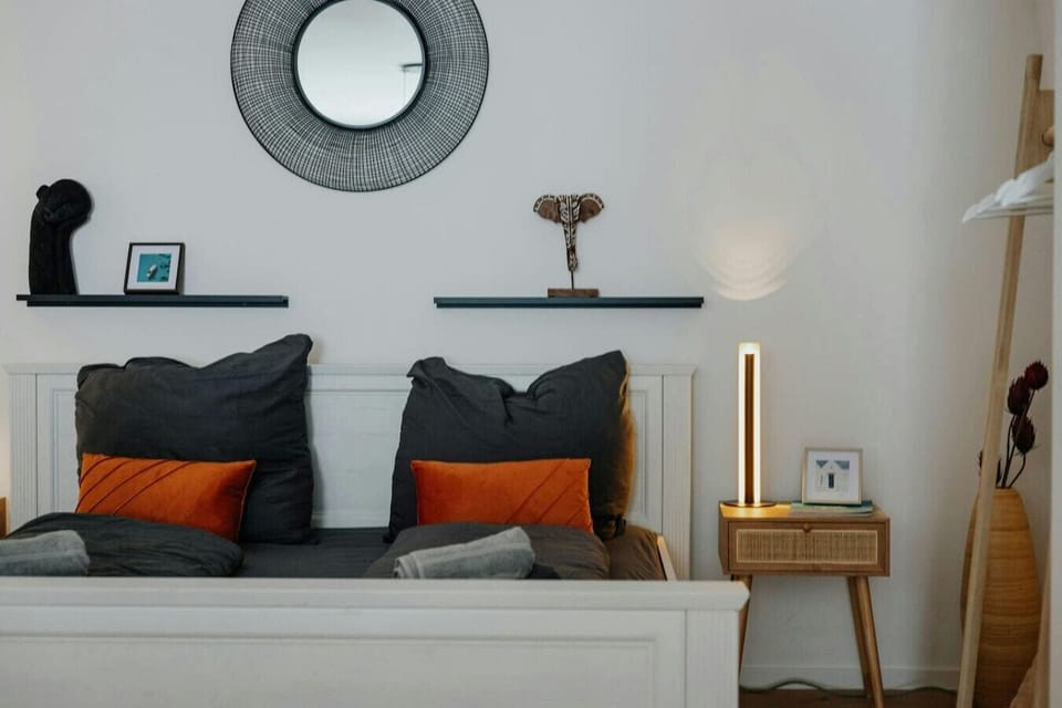 The cozy bed with nightstands and soft lighting.