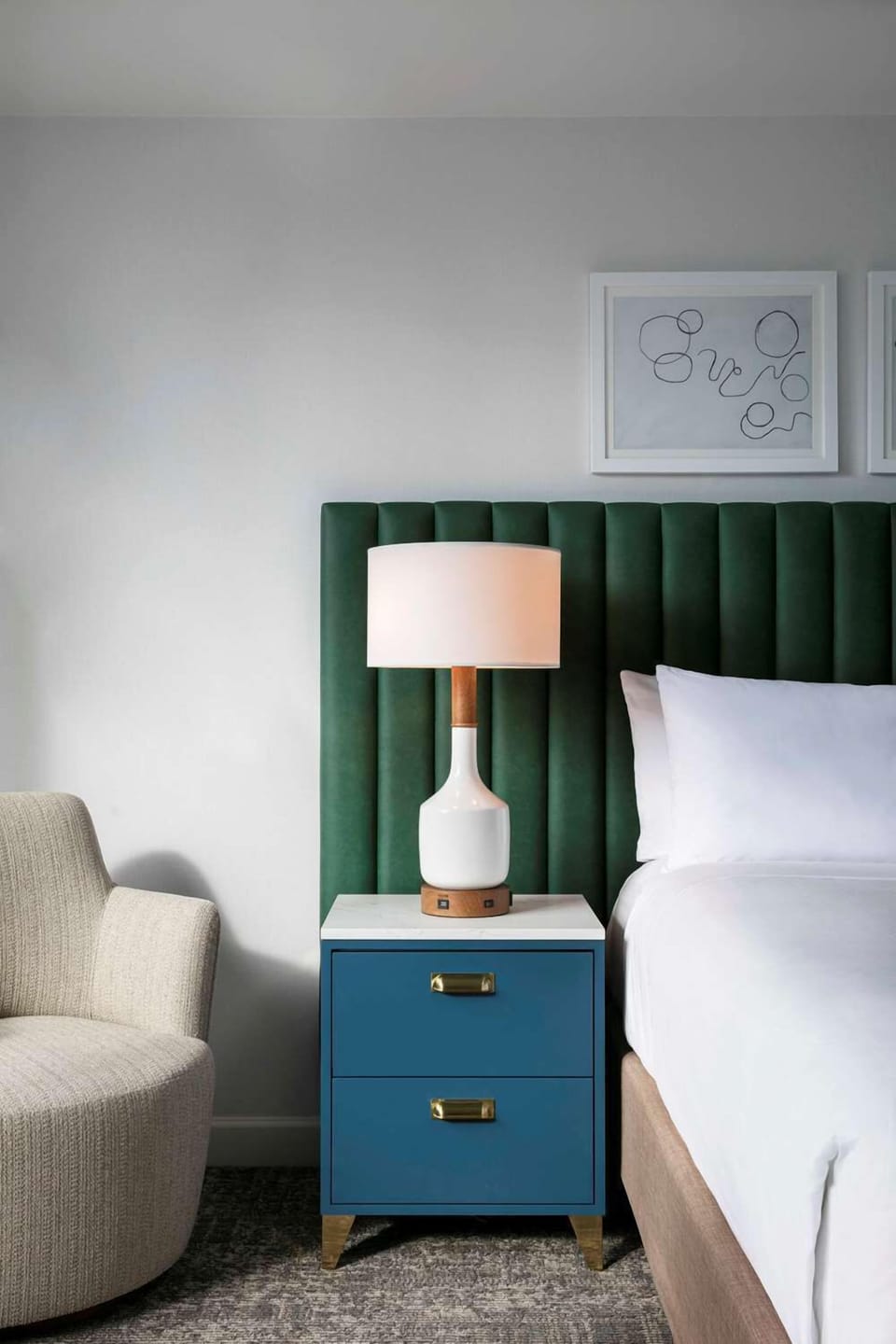 Settle in with soft lighting and designer bedside details.