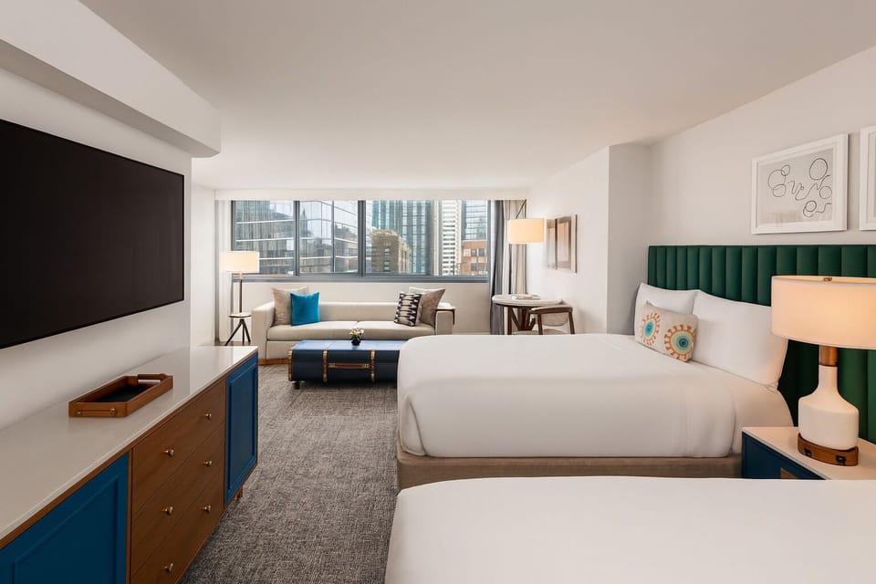 Settle into a spacious room with skyline views and plush beds.