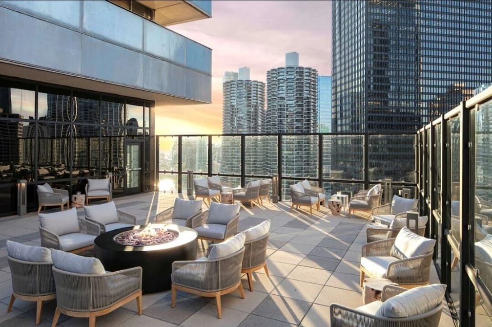 Sip cocktails by the fire with glowing skyline views.