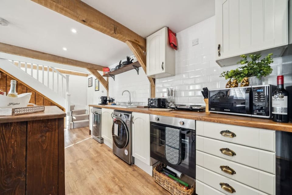 Modern kitchen with oven, hob, and Nespresso machine