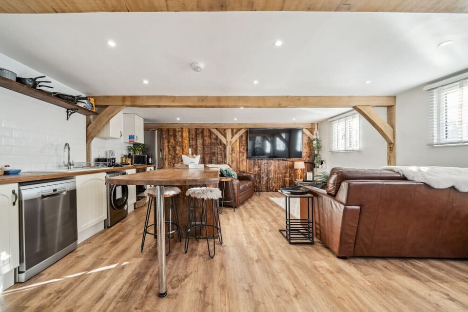 Kitchen bar area with stools and open-plan living