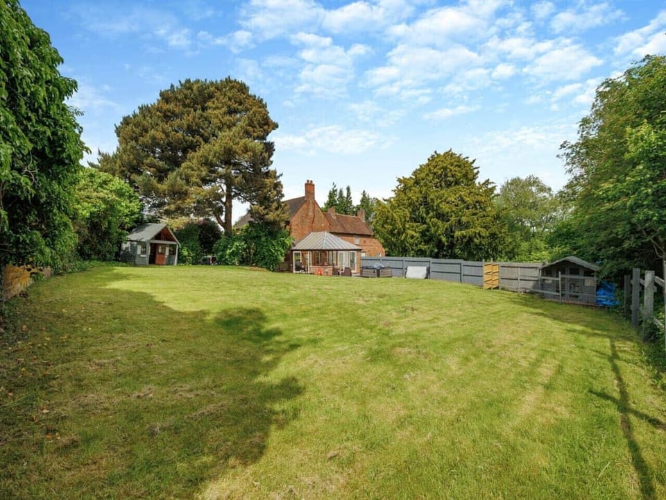 Expansive lawn surrounded by trees for privacy