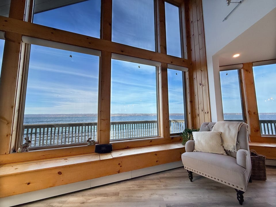 Lake views steal the show in this airy main living room, where natural light pours in and the deck is just steps away for indoor-outdoor bliss.