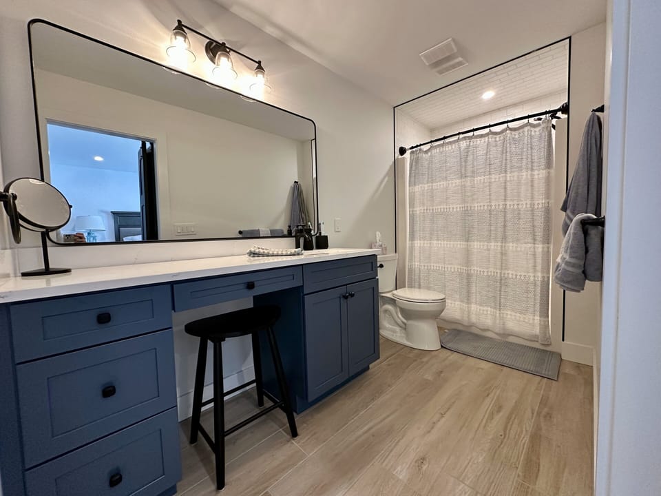 Located off of 1st floor primary, full bathroom with walk-in shower and vanity. 