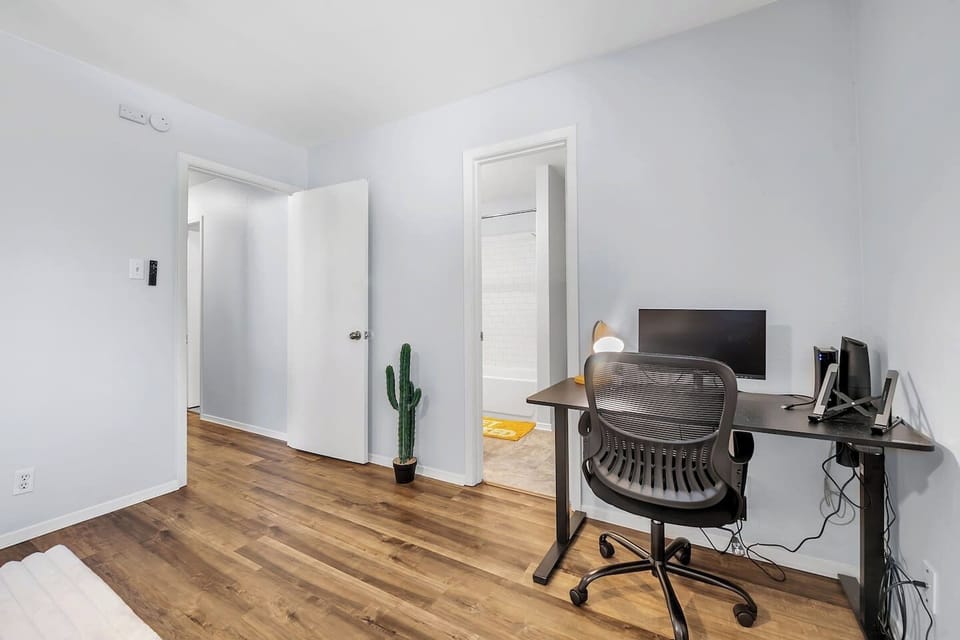 Cozy bedroom with a private bathroom and workspace.