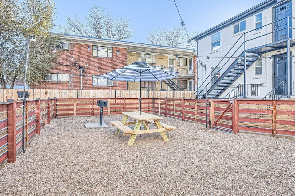 This charming wooden table is just waiting for some good food and even better company right in front of the building.