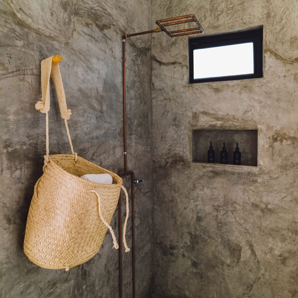 Rinse off under a rainfall shower in a spa-like space.
