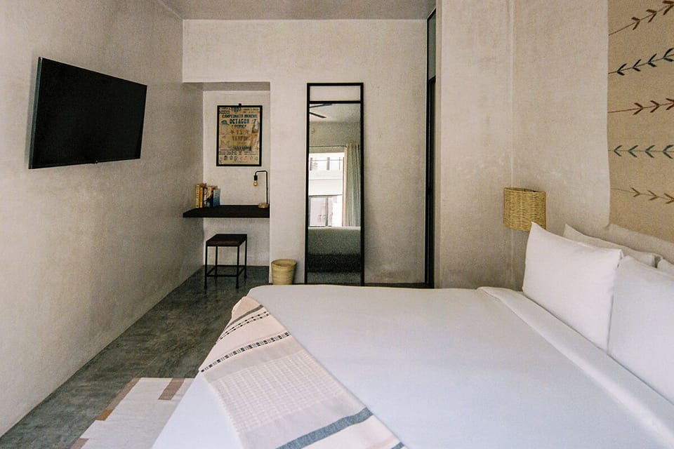 Unwind in a serene suite with minimalist, airy design.