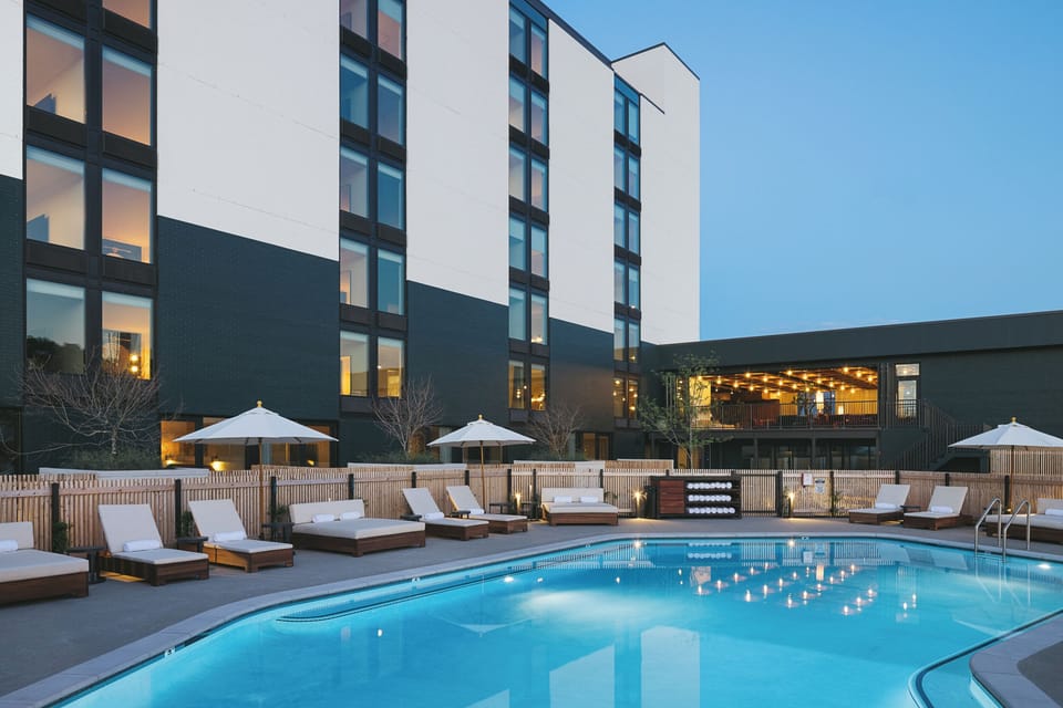 Dive into a sparkling evening swim under soft patio lights.